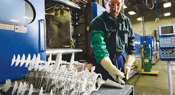 Technician removes gating material on magnesium parts