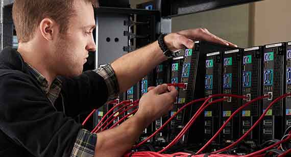 IT technician works on computer cluster