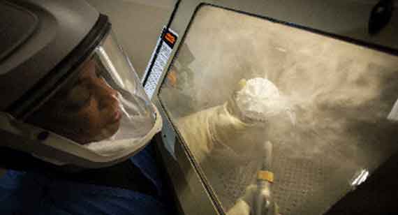 a 3D printing technician bead blasts a nylon SLS part